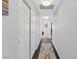Hallway with white walls and wood-look floors, featuring a closet and leading to other rooms at 600 Beresford Ave, Las Vegas, NV 89123