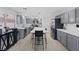 Bright eat-in kitchen featuring stainless steel appliances, gray cabinets and barstool seating at 600 Beresford Ave, Las Vegas, NV 89123