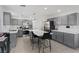 Modern kitchen featuring gray cabinetry, stainless steel appliances, and a marble island at 600 Beresford Ave, Las Vegas, NV 89123