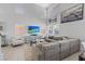 Bright living room featuring high ceilings, a comfortable sectional sofa, and large windows at 600 Beresford Ave, Las Vegas, NV 89123