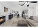 Open concept living room flowing into the kitchen with a fireplace and tile flooring at 600 Beresford Ave, Las Vegas, NV 89123