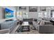 Open-concept living room with a large sectional sofa, windows, and modern décor at 600 Beresford Ave, Las Vegas, NV 89123