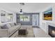 Cozy living room with fireplace, TV, gray walls, and a comfortable couch at 600 Beresford Ave, Las Vegas, NV 89123