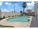 A refreshing backyard pool surrounded by well-maintained landscaping, a tall palm tree, and a cozy outdoor space at 600 Beresford Ave, Las Vegas, NV 89123