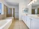 Bright bathroom with double vanity, soaking tub, and separate shower at 6120 Desert Haven Rd, Las Vegas, NV 89130
