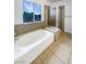 Bright bathroom featuring a garden tub with tiled surround and a separate shower at 6120 Desert Haven Rd, Las Vegas, NV 89130
