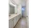 Bathroom with a dual sink vanity, ample storage, and tiled flooring at 6120 Desert Haven Rd, Las Vegas, NV 89130
