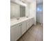 Bathroom with a dual sink vanity, ample storage, and tiled flooring at 6120 Desert Haven Rd, Las Vegas, NV 89130