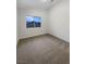 Cozy bedroom featuring a bright window and neutral carpeting at 6120 Desert Haven Rd, Las Vegas, NV 89130