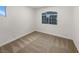 Bright bedroom with carpeted floors and a large window offering natural light at 6120 Desert Haven Rd, Las Vegas, NV 89130