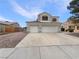 Two-story home featuring a three-car garage and desert landscaping at 6120 Desert Haven Rd, Las Vegas, NV 89130