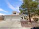 Two-story home featuring a three-car garage and desert landscaping at 6120 Desert Haven Rd, Las Vegas, NV 89130