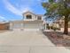 Two-story home featuring a three-car garage and desert landscaping at 6120 Desert Haven Rd, Las Vegas, NV 89130