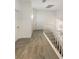 Upstairs hallway with neutral carpet, white railings, and modern lighting at 6120 Desert Haven Rd, Las Vegas, NV 89130