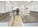 Spacious kitchen with white cabinets, granite countertops, and stainless steel appliances at 6120 Desert Haven Rd, Las Vegas, NV 89130