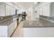 Well-lit kitchen with stainless steel appliances, granite countertops and tiled backsplash at 6120 Desert Haven Rd, Las Vegas, NV 89130