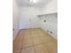 Functional laundry room with tile flooring, a storage shelf, and connections for washer and dryer at 6120 Desert Haven Rd, Las Vegas, NV 89130