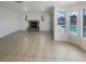 Open living room with a stone fireplace and view to the pool area at 6120 Desert Haven Rd, Las Vegas, NV 89130