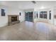 Bright living room with fireplace, tile floor, and large windows overlooking pool at 6120 Desert Haven Rd, Las Vegas, NV 89130