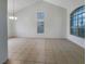 Open living room with tile flooring, high ceilings, and large windows for natural light at 6120 Desert Haven Rd, Las Vegas, NV 89130