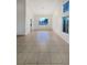Spacious living room featuring tile flooring and natural light from the large windows at 6120 Desert Haven Rd, Las Vegas, NV 89130