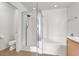 Bright bathroom featuring a glass enclosed shower, soaking tub, and all-white fixtures at 6581 Netherseal Ave, Las Vegas, NV 89139