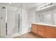 Bright bathroom featuring a glass enclosed shower, soaking tub, and double sink vanity at 6581 Netherseal Ave, Las Vegas, NV 89139