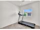 Bedroom featuring a window with backyard view and a black treadmill at 6581 Netherseal Ave, Las Vegas, NV 89139