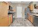 Kitchen with stainless steel appliances, light cabinets, and stylish floors at 6581 Netherseal Ave, Las Vegas, NV 89139