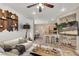 Bright living room with a ceiling fan, rustic wooden decor, and view of kitchen at 6581 Netherseal Ave, Las Vegas, NV 89139