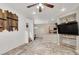 Bright living room featuring an open floor plan and modern flooring, leading to the kitchen and dining area at 6581 Netherseal Ave, Las Vegas, NV 89139