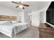 Bright main bedroom with carpet, television, ceiling fan, and en suite bathroom at 6581 Netherseal Ave, Las Vegas, NV 89139