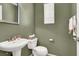 Powder room featuring a pedestal sink and ample storage space at 6581 Netherseal Ave, Las Vegas, NV 89139