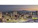 Panoramic cityscape shot with lighted buildings under a twilight sky, and mountains in the distance at 700 W Carson Ave # 2307, Las Vegas, NV 89106