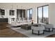 Open-concept living room with stylish seating, city views, and a modern kitchen in the background at 700 W Carson Ave # 2307, Las Vegas, NV 89106