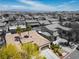 Stunning aerial view of a tan, tile roof home in a quiet neighborhood in Las Vegas with city skyline in the background at 7206 Laramie Ave, Las Vegas, NV 89113