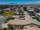 An aerial view of a desert property with a spacious tile roof and a luxurious pool at 7206 Laramie Ave, Las Vegas, NV 89113