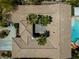 Birds-eye view of terracotta roof tiles, surrounded by desert landscaping with a pool nearby at 7206 Laramie Ave, Las Vegas, NV 89113
