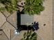 An aerial view showcasing a terracotta tile roof, a desert landscape, and palm trees at 7206 Laramie Ave, Las Vegas, NV 89113