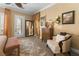 Cozy bedroom featuring a sitting area, neutral tones, and plenty of natural light at 7206 Laramie Ave, Las Vegas, NV 89113