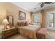 Warm bedroom featuring a comfortable queen-sized bed with patterned bedding and soft pillows at 7206 Laramie Ave, Las Vegas, NV 89113