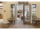 Foyer view to the covered patio with tiled floors and decorative chairs at 7206 Laramie Ave, Las Vegas, NV 89113