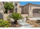 Charming home featuring stone accents, desert landscaping, and a well-manicured lawn at 7206 Laramie Ave, Las Vegas, NV 89113