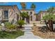Inviting home featuring desert landscaping and palm trees on a sunny day at 7206 Laramie Ave, Las Vegas, NV 89113