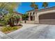 Charming single Gathering home with desert landscaping, palm trees, and a driveway at 7206 Laramie Ave, Las Vegas, NV 89113