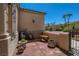 Inviting front porch features decorative pots, wrought iron details, and a charming chair on a sunny day at 7206 Laramie Ave, Las Vegas, NV 89113