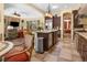 Open kitchen featuring a central island with stainless steel appliances, seamlessly connected to a cozy living area at 7206 Laramie Ave, Las Vegas, NV 89113