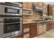 Modern kitchen featuring stainless steel appliances, granite countertops, and custom cabinetry for a sleek cooking experience at 7206 Laramie Ave, Las Vegas, NV 89113
