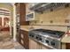 Well-equipped kitchen with stainless steel gas range, custom cabinets, and granite countertops perfect for culinary enthusiasts at 7206 Laramie Ave, Las Vegas, NV 89113