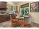 Charming kitchen nook with a round table, seating for four, cabinetry and bright window offering a cozy dining space at 7206 Laramie Ave, Las Vegas, NV 89113
